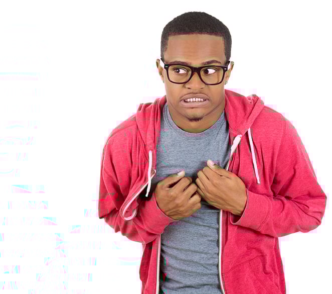 Closeup portrait of a young nerdy looking man with glasses, very timid, shy and anxious, playing with hands nervously, isolated on a white background. Mental health, emotion facial expression feeling