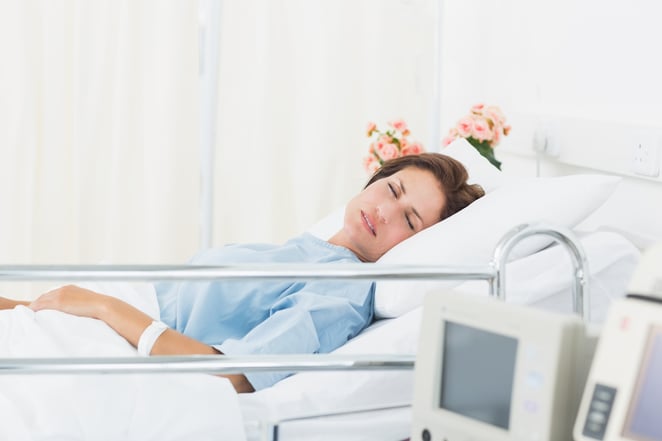 Female patient sleeping in medical bed at the hospital ward-1