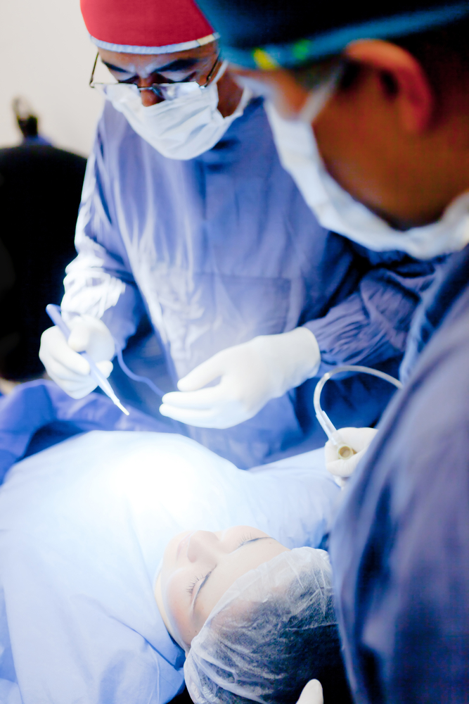 Group of surgeons operating on a patient-1